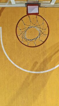 Overhead View of Basketball Players Contesting a Dunk at the Rim
