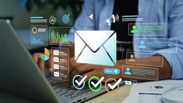 Business person using laptop with glowing hologram email icon and digital charts animation, Email marketing communication, customer outreach, analytics and online messaging in a modern office