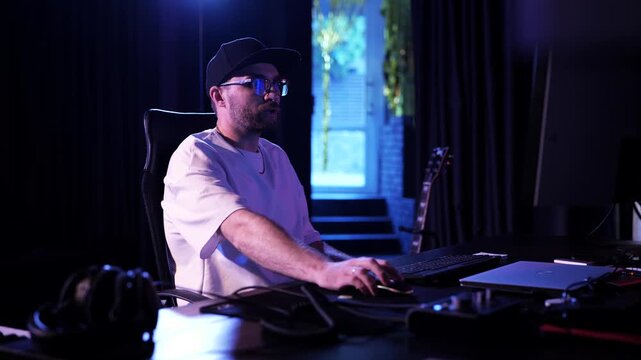 Music Producer Working At Computer In Professional Recording Studio
