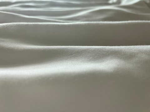 White satin fabric texture with soft natural light