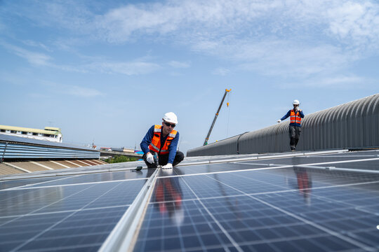 Team of professionals installing solar panels on a rooftop to promote renewable energy and enhance sustainability efforts