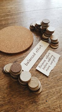 Low Attention Span: Stacked Coins and Cork Circle Illustrating Balanced Effort and Planning
