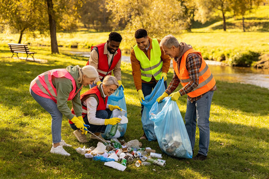 volunteers cleaning up litter in the park, making environment clean