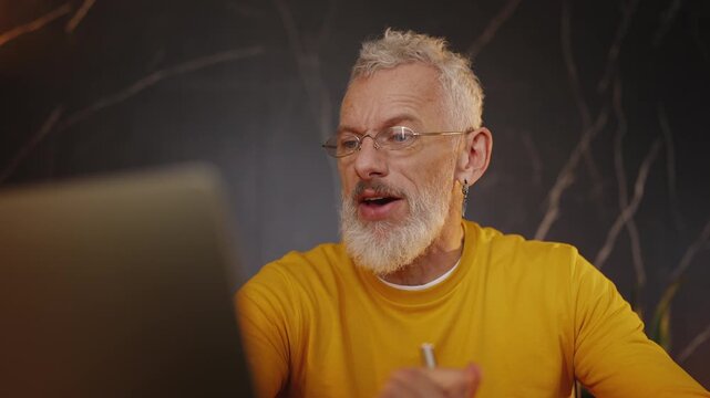 Businessman discussing a contract with a partner during a laptop video call