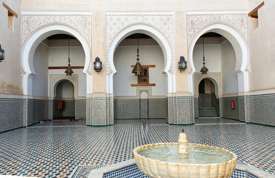 Arched colonnade courtyard with fountain at mausoleum of moulay ismail in meknes. Morocco.