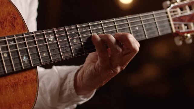 Close-up of fingers playing acoustic guitar chords on fretboard, soft focus background