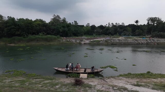Rural river crossing with small boat carrying people and goods serene natural landscape with lush