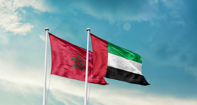 Morocco and UAE friendship flags are waving in the sky. Double country Flag waving with mast. Morocco UAE national flag for agreement.