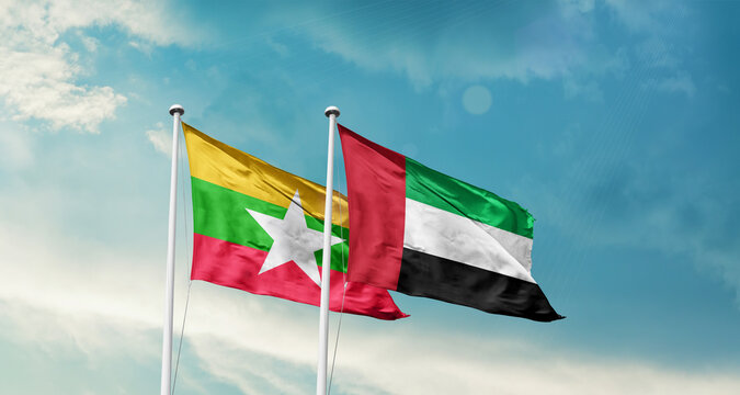 Myanmar (Burma) and UAE friendship flags are waving in the sky. Double country Flag waving with mast. Myanmar Burma UAE national flag for agreement.