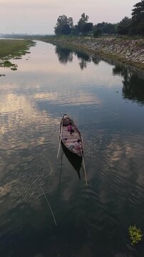 Serene river journey traditional wooden boat gentle ripples reflecting sky peaceful rural scenery