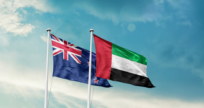 New Zealand and UAE friendship flags are waving in the sky. Double country Flag waving with mast. New Zealand UAE national flag for agreement.