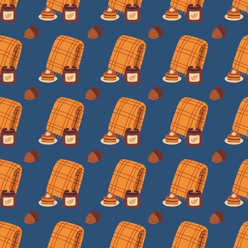 Cozy autumn seamless pattern with plaid blanket, candle, pie slice, and acorns on dark blue background