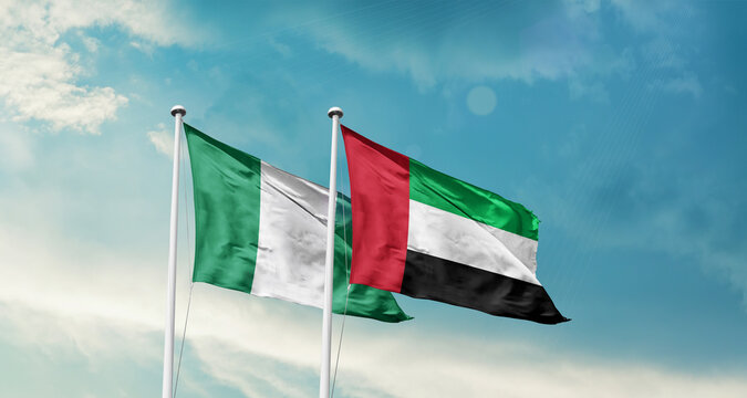 Nigeria and UAE friendship flags are waving in the sky. Double country Flag waving with mast. Nigeria UAE national flag for agreement.