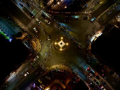 Aerial view of Tugu Yogyakarta Monument at night, with illuminated traffic flowing through the roundabout in Kecamatan Jetis, Daerah Istimewa Yogya, Indonesia.