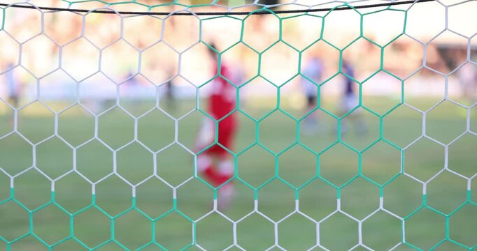 Soccer, football match. Blurred view of football match. Focus on the football net
