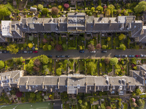 Aerial view of the historic Ann Street with its Georgian houses, lush private gardens, and cobblestone road in Edinburgh, Scotland, United Kingdom.