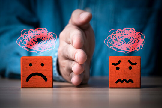 Conflict management concept with a hand separating two negative emotions, symbolizing workplace conflict, disagreement, mediation, communication, emotional control, resolution and teamwork.