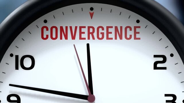 Convergence that is going to happen soon. Upcoming convergence, approaching in the near future. Convergence almost here, in a short time - a clock symbolizes a reminder that convergence is near.