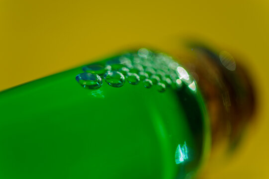 Air bubbles in a glass container with emerald liquid.