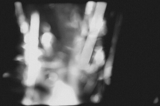retro film overlay effect with scratch dust and light leaks, retro grain noisy film distressed texture light leak flare on black background,black and white abstract light background