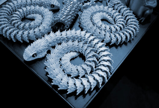 Art models printed on 3D printer. Different objects created on 3D printer from molten plastic. 3D printed different objects. Modern new modern additive progressive technologies. 3D printing technology