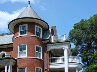 Obraz premium Residential building with round turret and upper level veranda or balcony