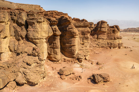 Aerial view of the dramatic red sandstone rock formations at Timna Park, featuring rugged desert cliffs and vast sandy terrain in Eilat, South District, Israel.