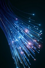 Fototapeta premium Fiber optic cables create light patterns in a dark setting during a technology showcase
