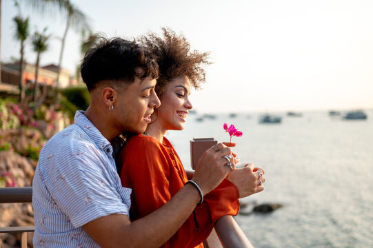 Married couple celebrates their love and bond through a quiet, intimate moment on the beach