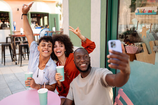 Joyful group of diverse friends celebrates life, happiness, inclusion as they take a cheerful selfie