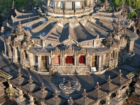 Aerial view of the Bajra Sandhi Monument in Renon featuring intricate Balinese stone carvings and a traditional tiered roof structure in Denpasar Selatan, Bali, Indonesia.