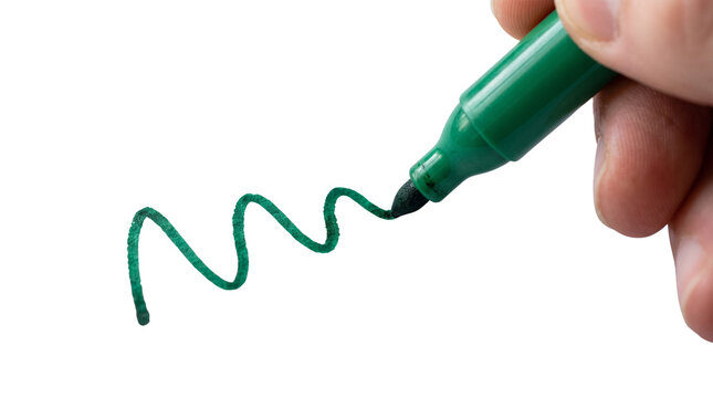 Green felt tip marker drawing a wavy line, hand holding permanent marker pen on white background, creative art and office supply concept