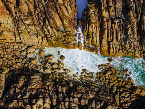Aerial view of Injidup Natural Spa with turquoise water crashing against rugged rock formations in Yallingup, Western Australia, Australia.