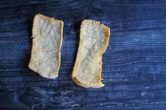 Crispy Javanese rambak snack isolated on a black background.