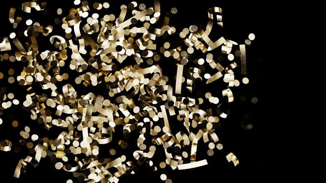 Sparkling gold glitter pieces and metallic ribbons slow motion explosion