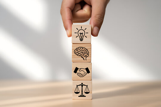 Hand stacking wooden cubes with icons