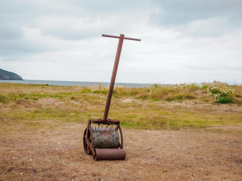 abandoned links golf course putting green spiking roller with the ocean in the background
