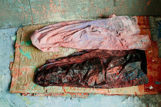 Close up shot of paint stained fabric lying on studio floor, representing contemporary artist workflow and creative process. Supporting art education, workshop promotion, maker branding