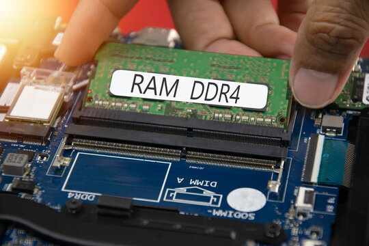 The image shows DDR4 RAM being installed on the motherboard.