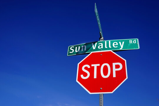 Bright Red Stop Sigh on Sun Valley Road in Resort Town in Idaho with Sky in Background