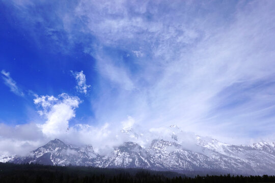 View of the Teton Mountain Range Grand Teton Mountains in Winter Snow Storm Snowstorm with Clouds Dramatic Wilderness