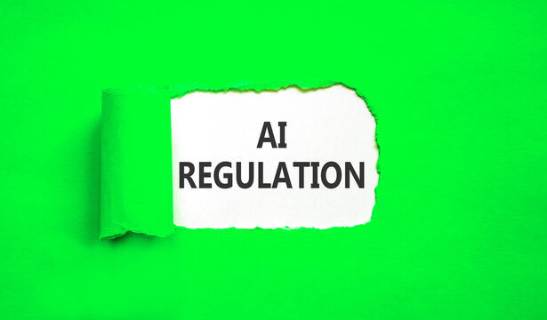 AI regulation symbol. Concept words AI artificial intelligence regulation on beautiful white paper. Beautiful green background. Business AI artificial intelligence regulation concept. Copy space.