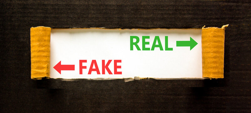 Real or fake words symbol. Concept words Fake and Real on beautiful white paper. Beautiful black background. Business and real or fake concept. Copy space.