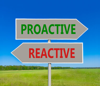 Proactive and reactive symbol. Concept word Proactive Reactive on beautiful grey road sign. Beautiful blue sky background. Business proactive and reactive concept. Copy space.
