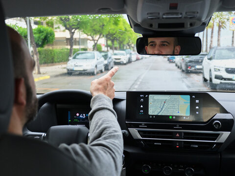 Person navigating new city with GPS in car