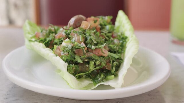 Delicious tabbouleh salad, a classic levantine dish, served fresh in a restaurant setting