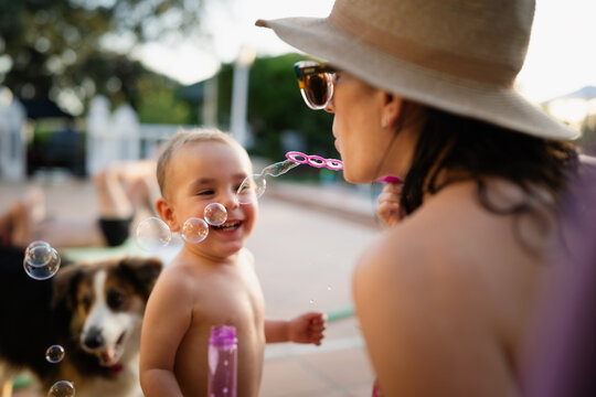 Mother and child blowing bubbles