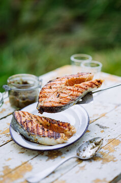 Freshly grilled salmon served on a rustic table outdoors