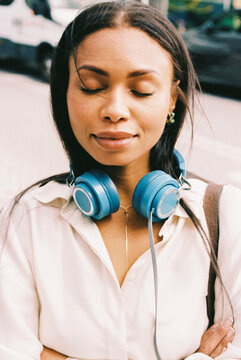 Woman with blue headphones Urban outdoors film photo