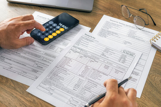 Businessman filling out personal tax return form